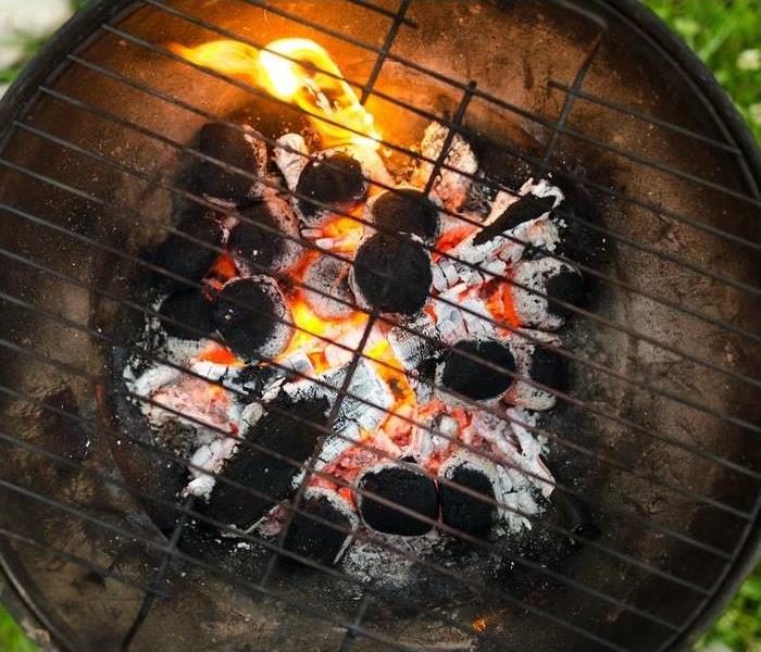 BBQ grill with flames and charcoal